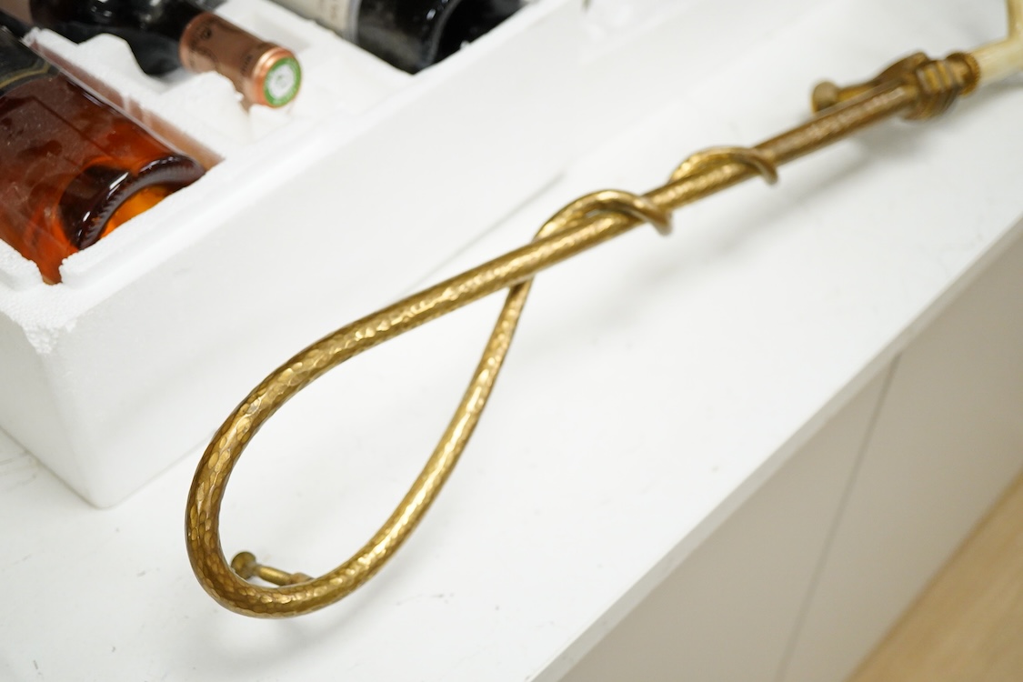 An unusual early 20th century gilt bronze or brass ‘riding crop and hand’ door handle, 65cm